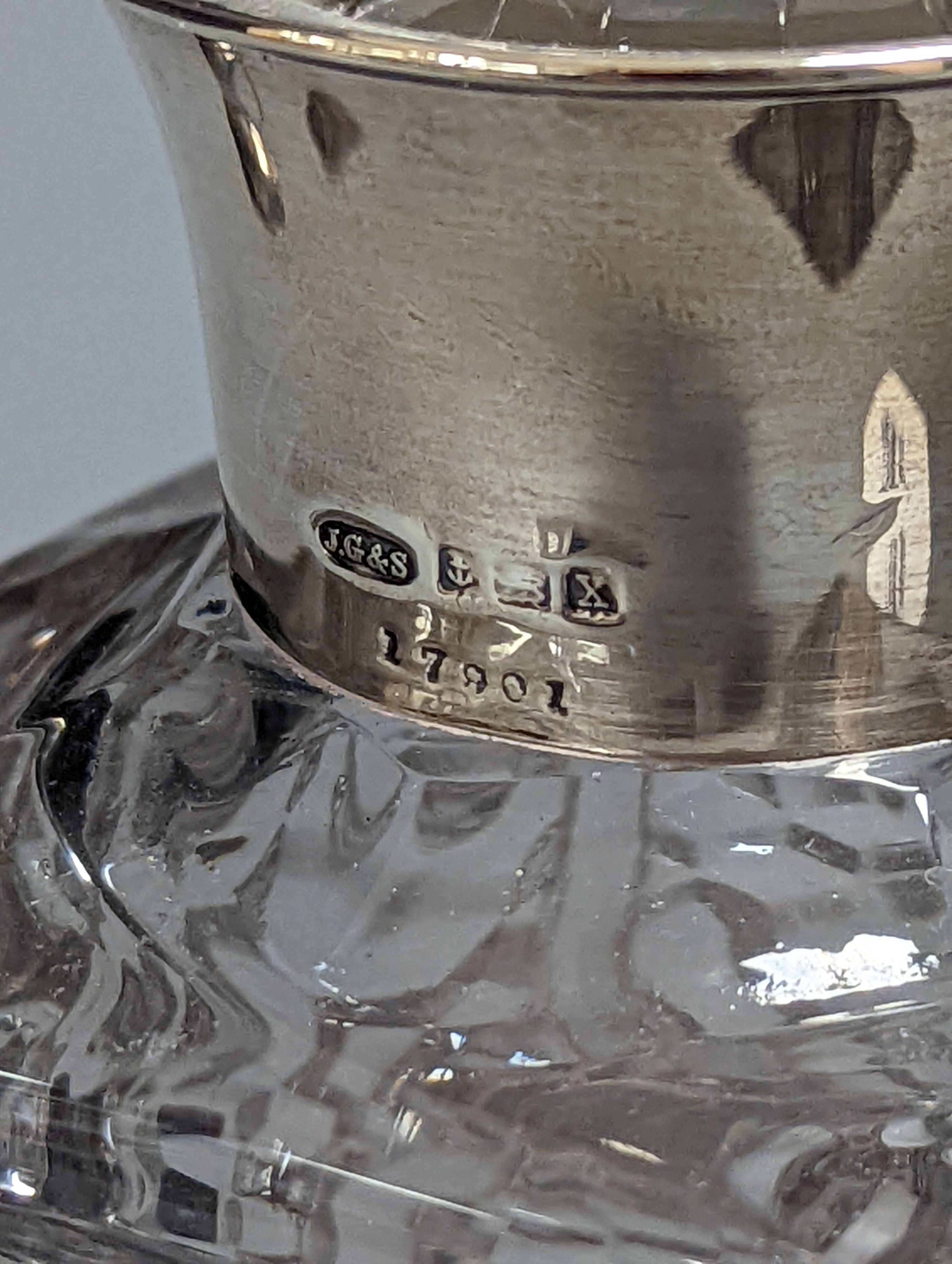 A pair of silver mounted cut glass spirit decanters and a ‘GIN’ spirit label